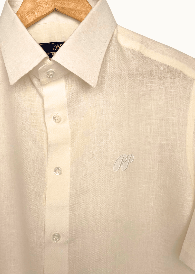Oyster Belgian Linen shirt on a wooden hanger with a close-up of the collar and buttons.