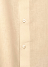 Close-up of a beige linen shirt with button details