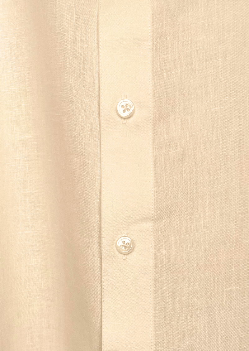 Close-up of a beige linen shirt with button details